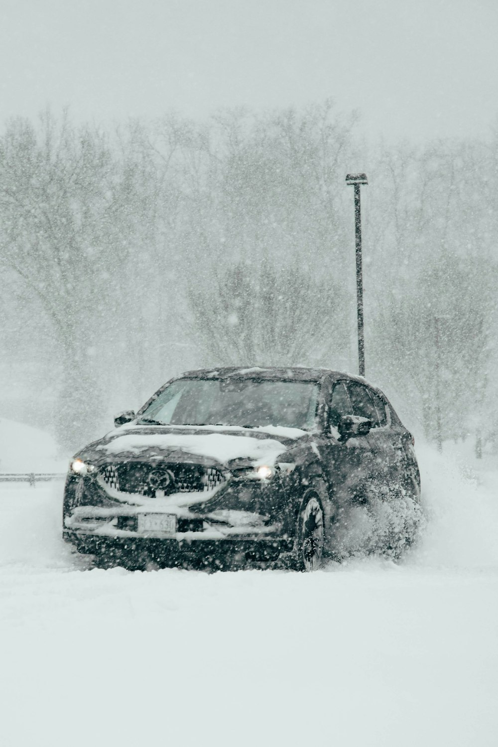 a car driving down a snow covered road