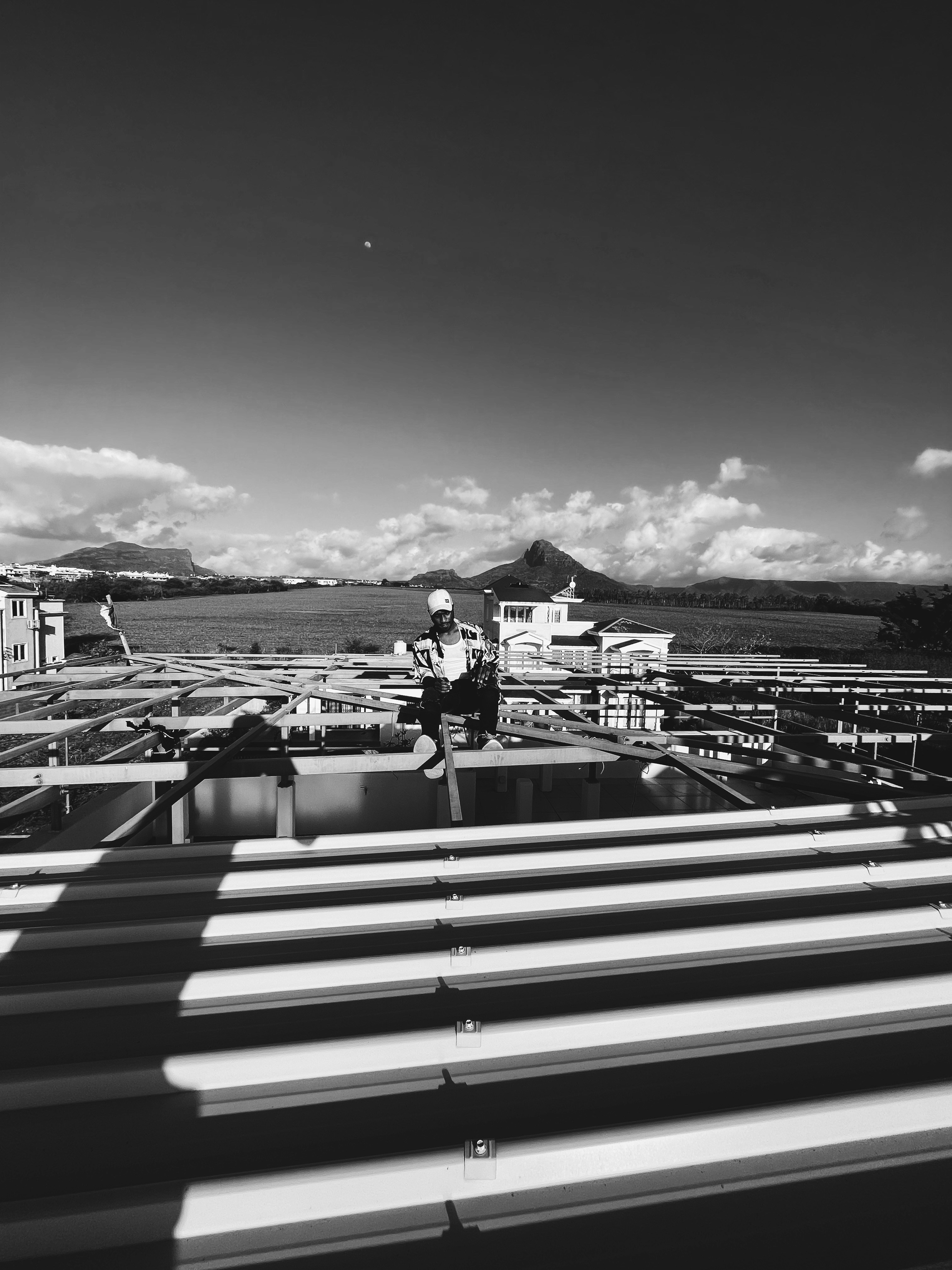 a man standing on top of a metal roof