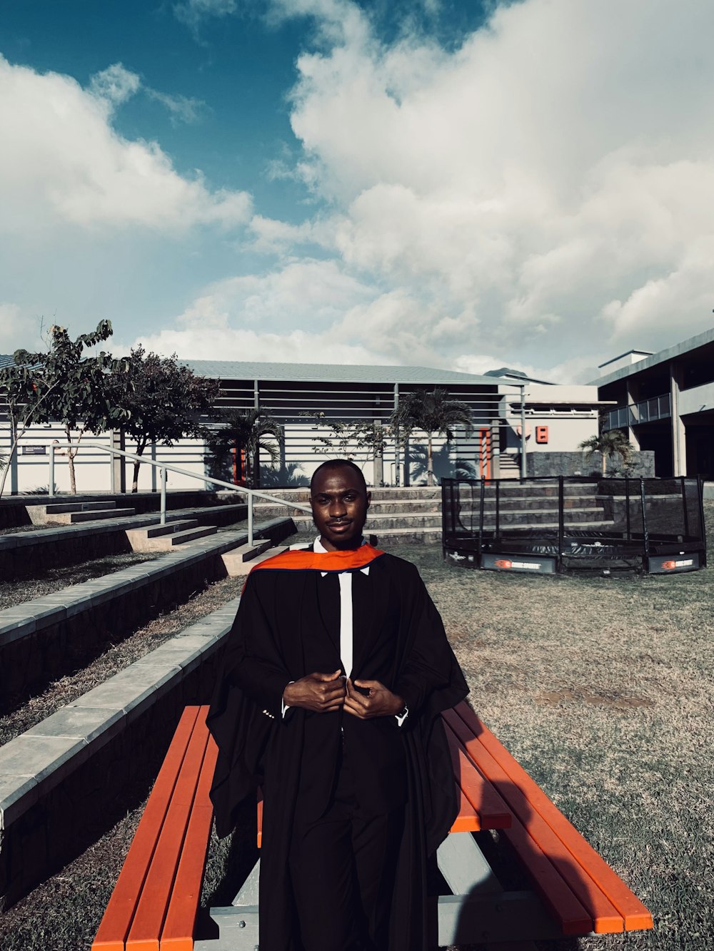 a man in a robe sitting on a bench