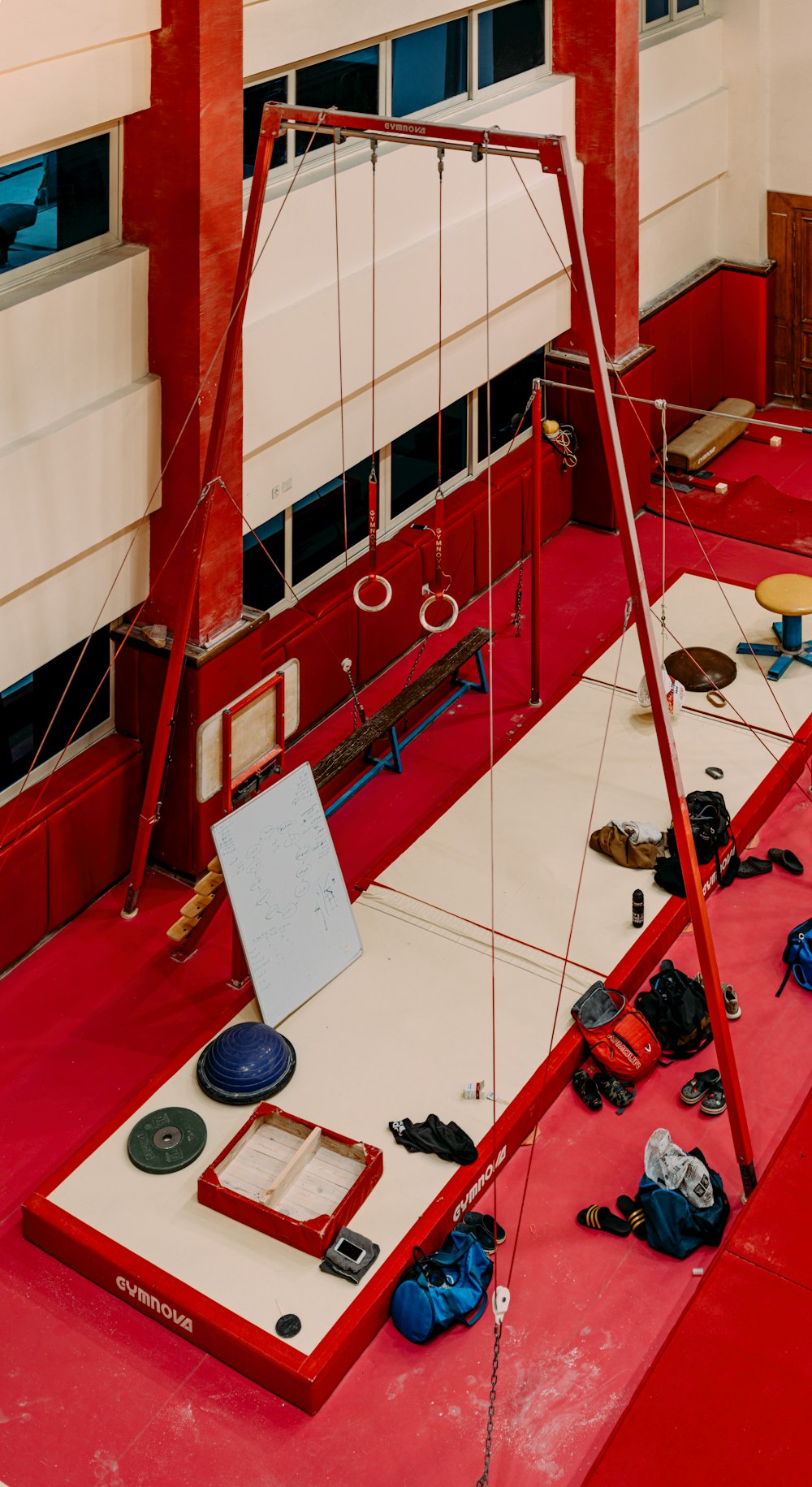 a room with a red floor and a suspended object