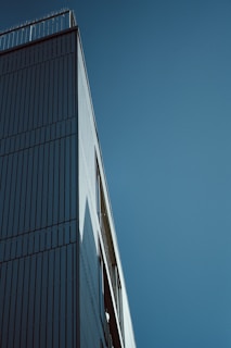A modern building exterior showcasing smooth plaster walls and clean architectural lines under a clear sky.