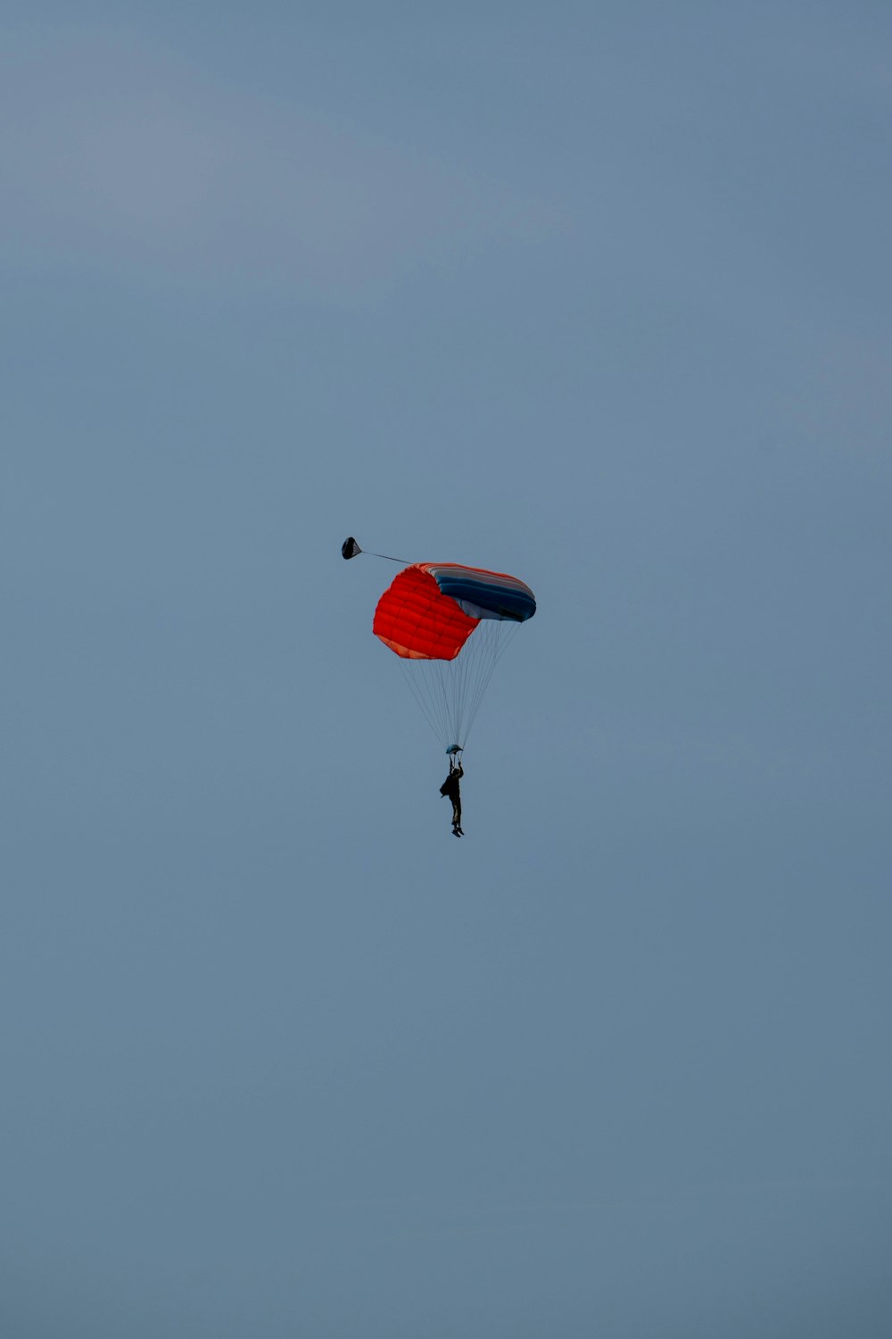 a person is parasailing in the sky with a parachute