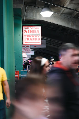 The Diamond Bites concession stand bustling with fans enjoying their favorite ballpark treats during a lively softball game.