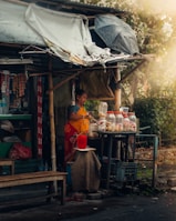 a woman standing in front of a food stand