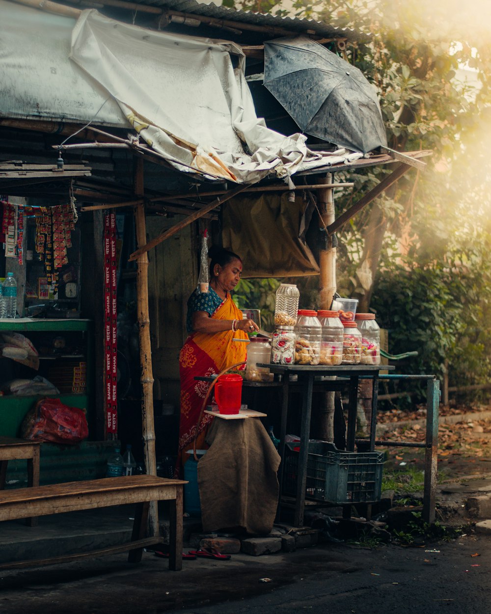 a woman standing in front of a food stand