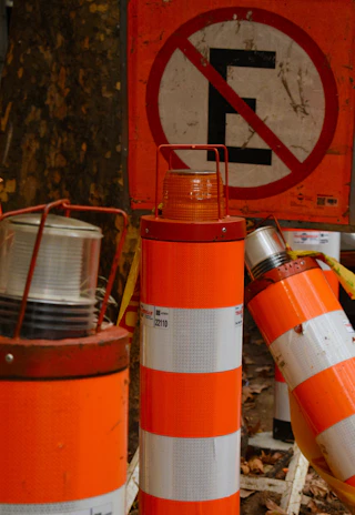 Traffic cones and signage arranged precisely along a busy California street.