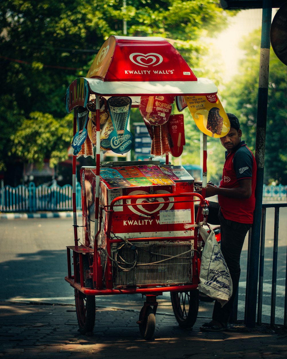 a man standing next to a food cart