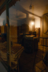 Close-up image of artisans hand-knotting luxurious rugs in a dimly lit workshop.