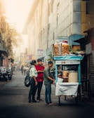 A street vendor handing out free samples to excited passersby on a sunny day