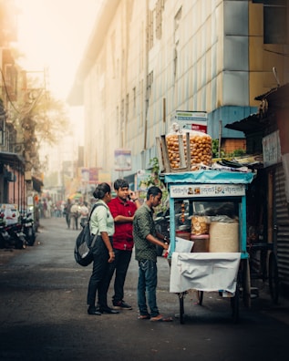 A street vendor handing out free samples to excited passersby on a sunny day