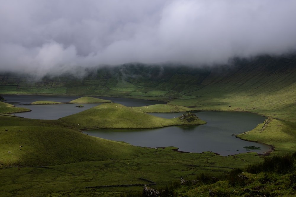 a large body of water surrounded by lush green hills