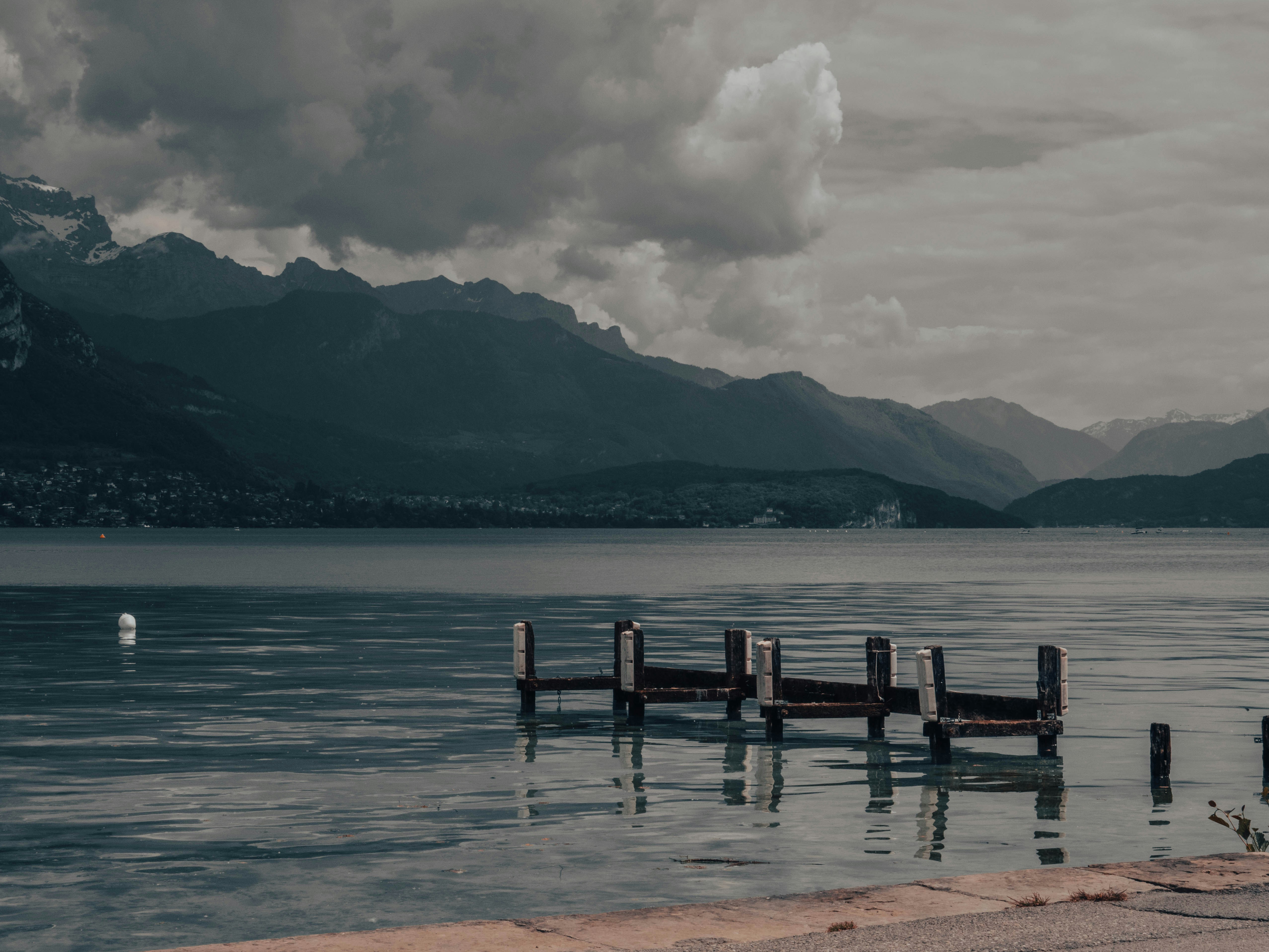 a body of water with mountains in the background, 