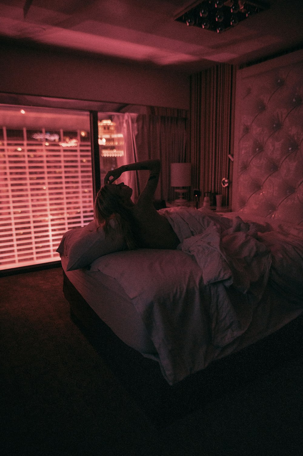 a person laying on a bed in a dark room