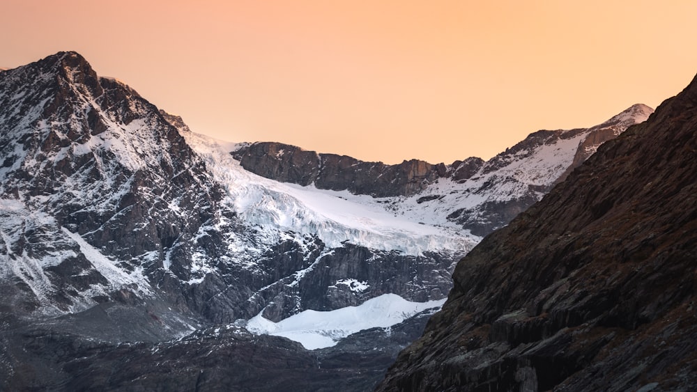 a mountain range with snow covered mountains in the background