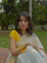 a woman in a yellow and white sari