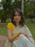 a woman in a yellow and white sari
