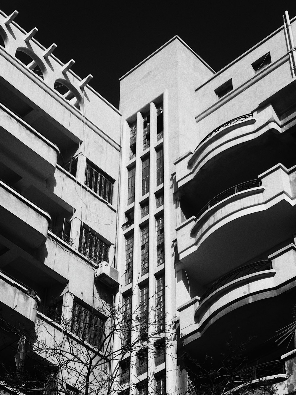 a black and white photo of a building with balconies