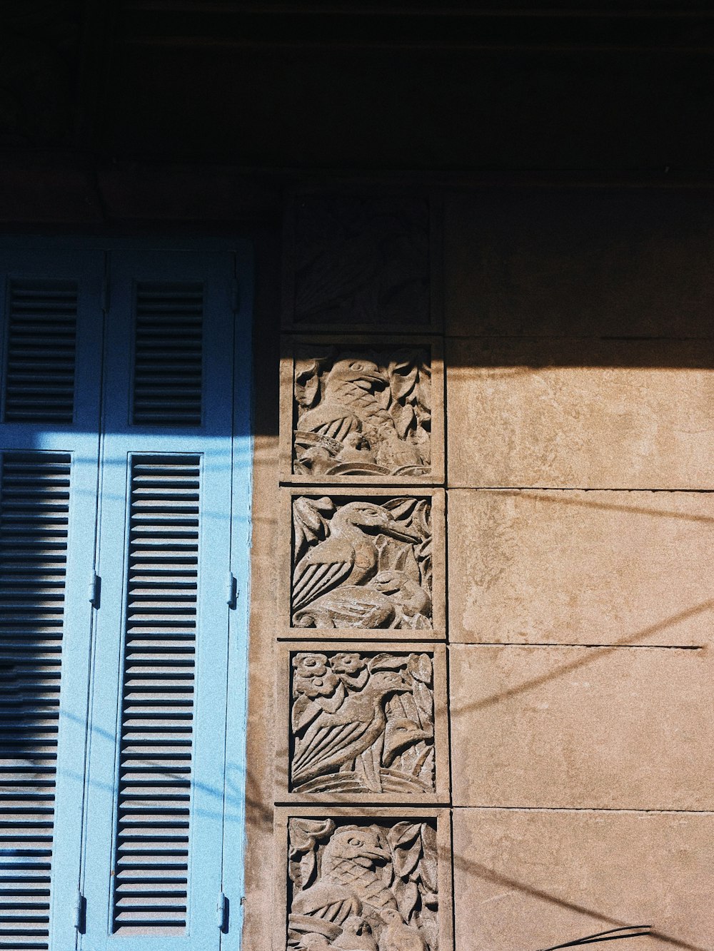 a building with a blue window and shutters