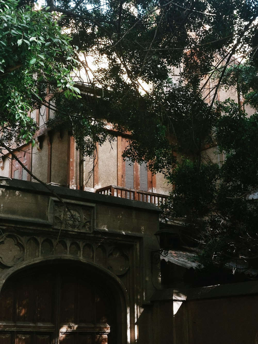 an old building with a wooden door and balcony