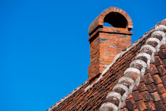 a brick chimney with a blue sky in the background