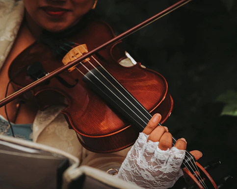 a woman holding a violin in her right hand
