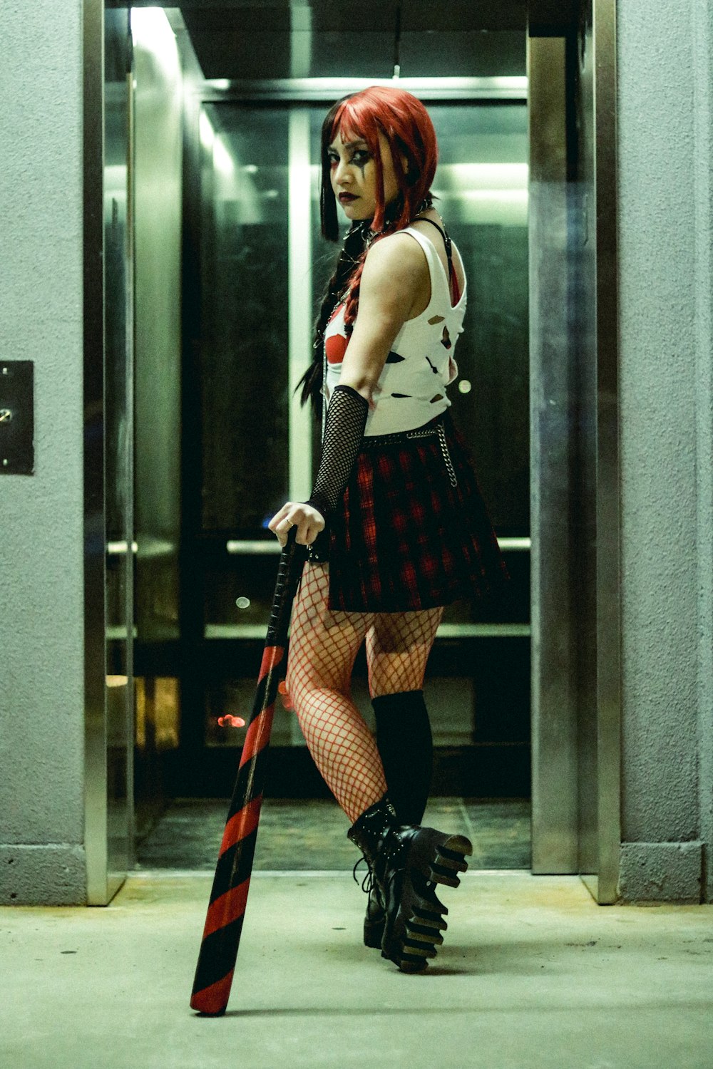 a woman in a short skirt holding a bat