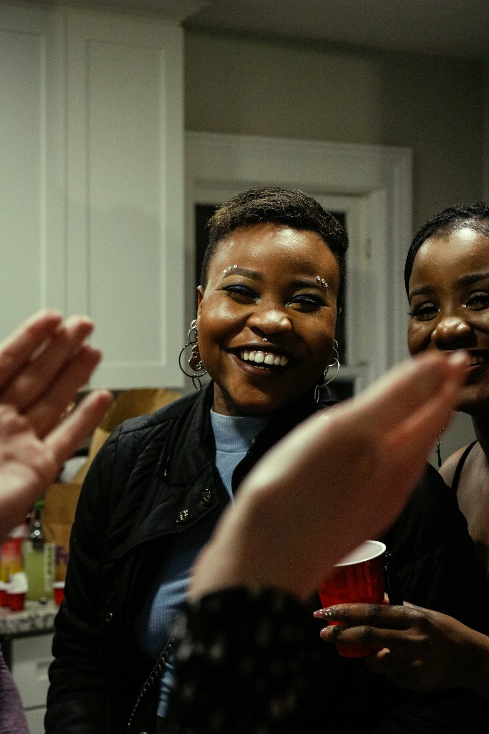 a group of women standing next to each other in a kitchen