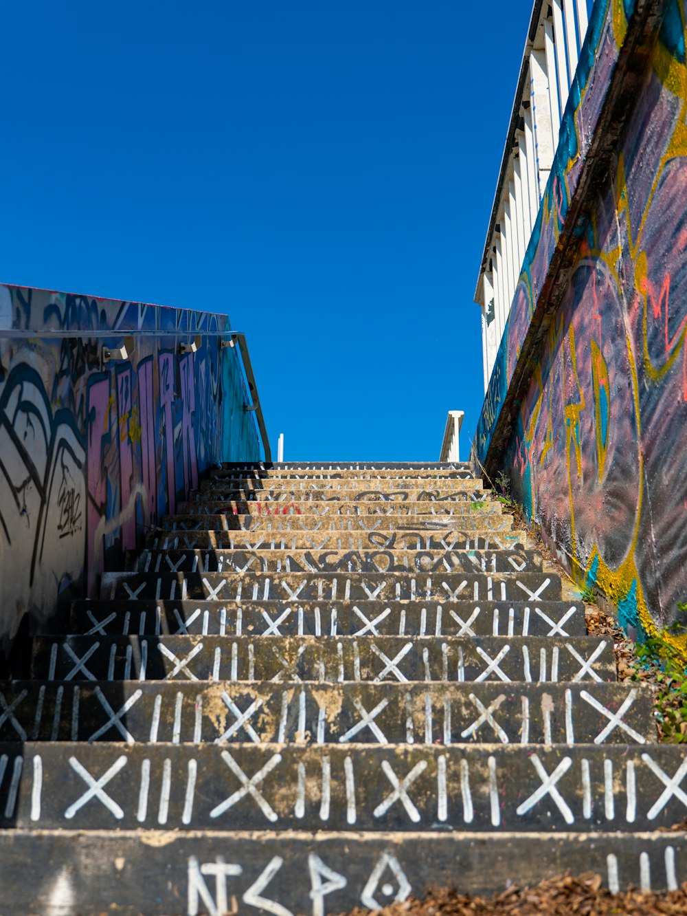 a set of stairs covered in graffiti next to a building