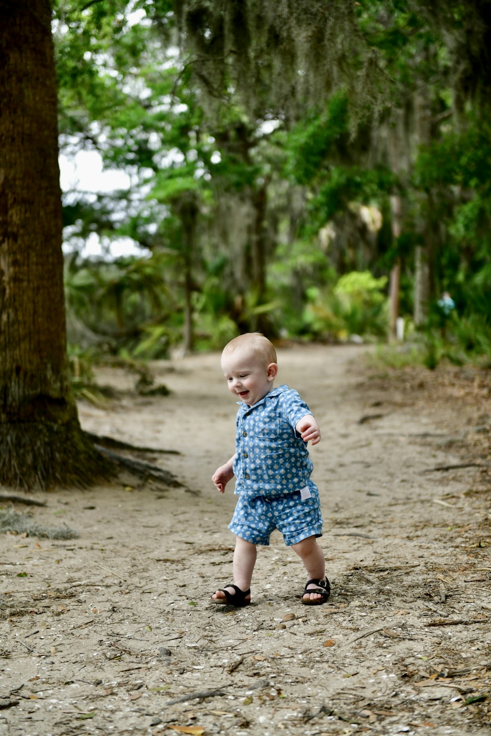 a little boy that is standing in the dirt