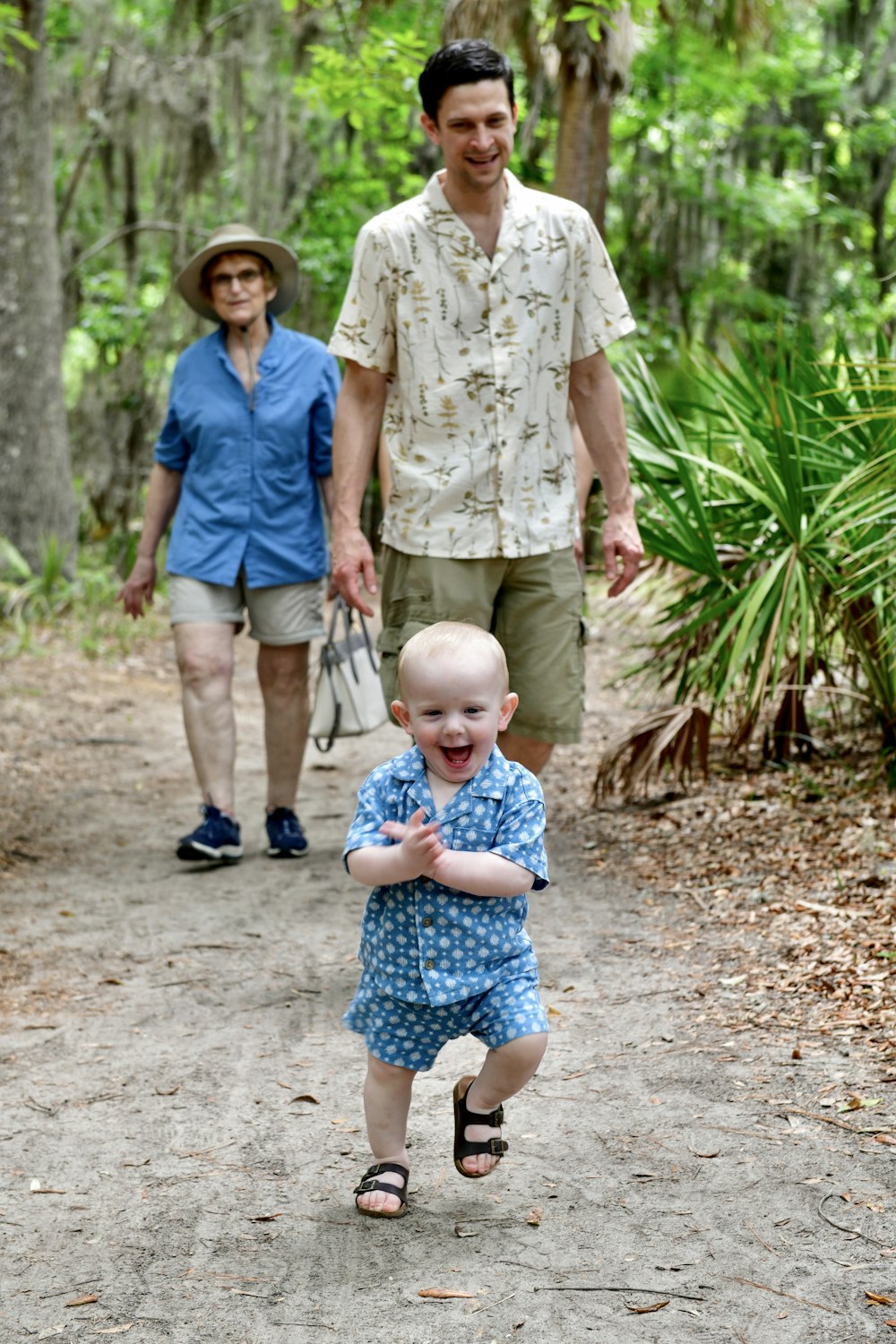 a man and a woman walking down a dirt road