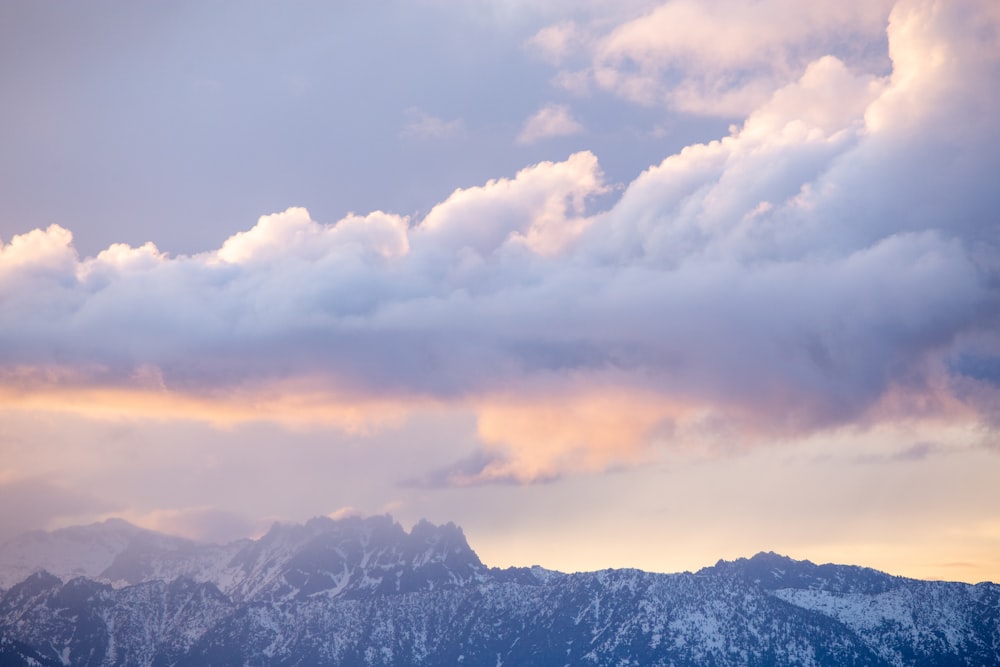 a view of a mountain range under a cloudy sky