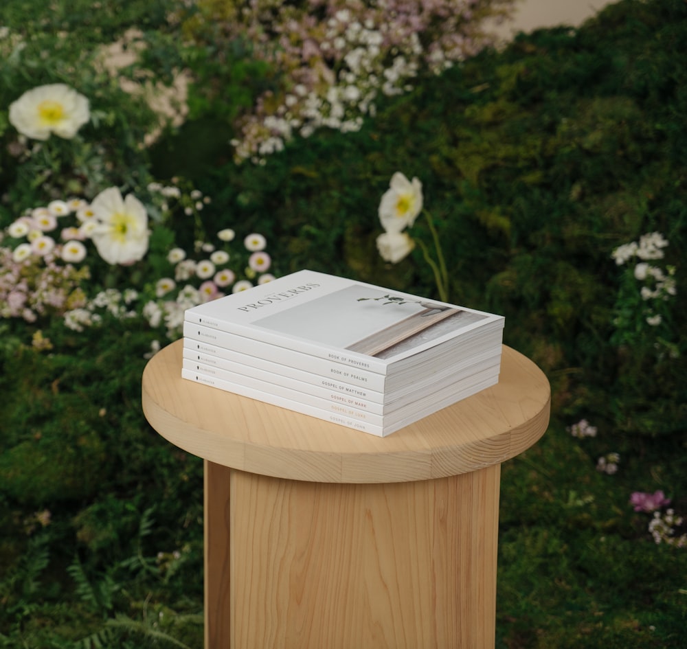 a stack of books sitting on top of a wooden table