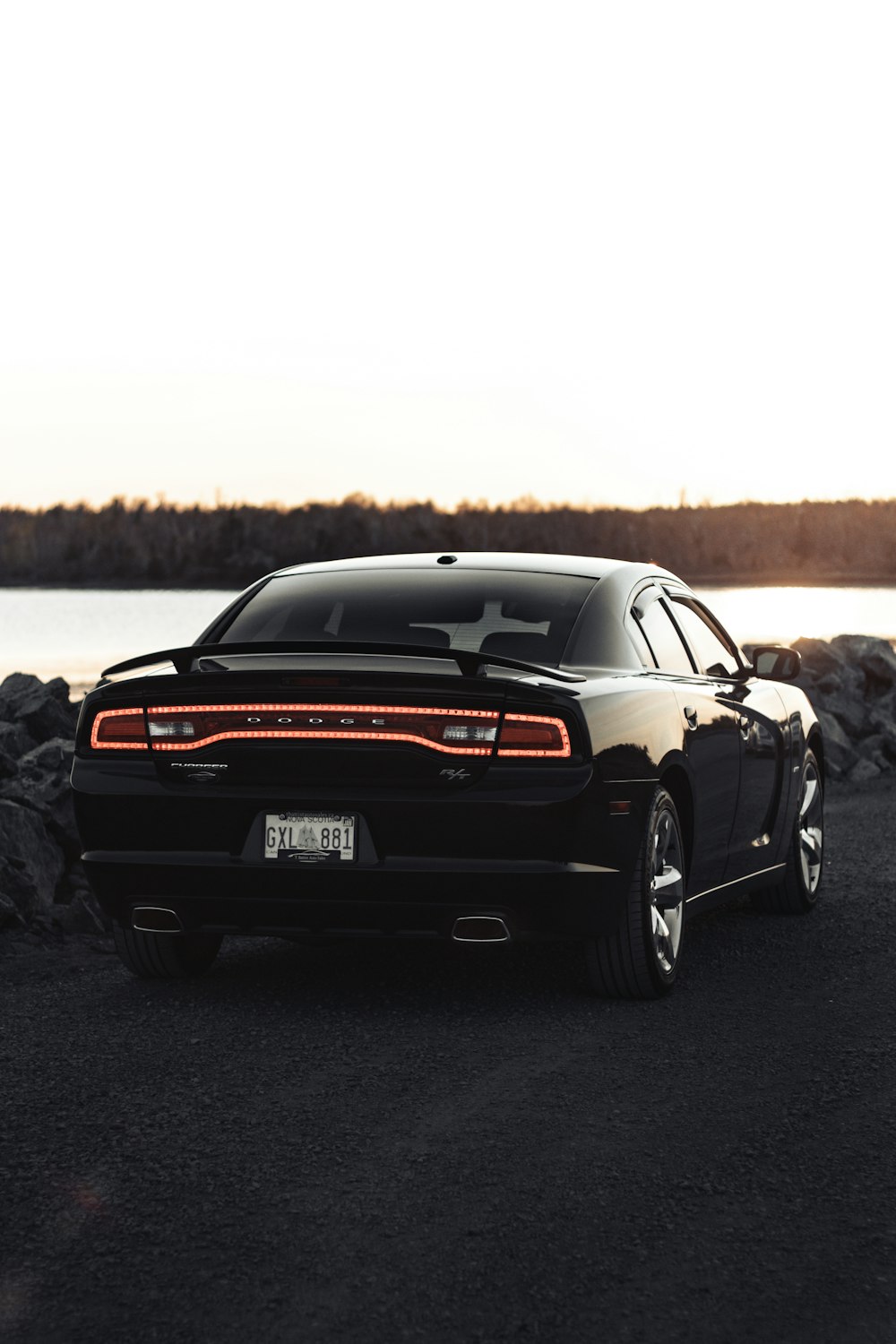 a black car parked on the side of a road