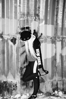 Model wearing a deep navy hoodie standing against a snowy urban backdrop in Noida