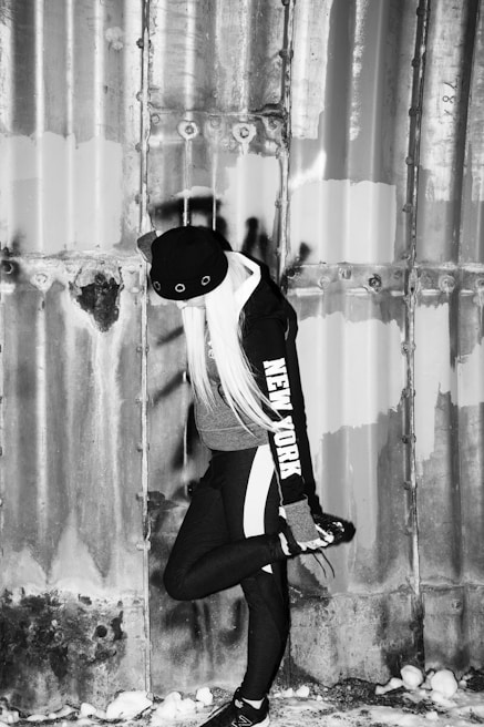 Model wearing a deep navy hoodie standing against a snowy urban backdrop in Noida