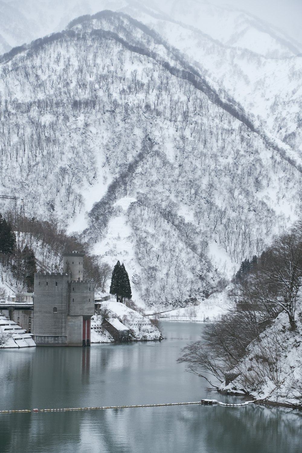 a large body of water surrounded by snow covered mountains