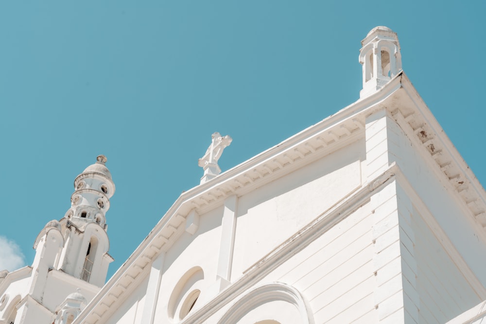 a white church with a steeple and a cross on top