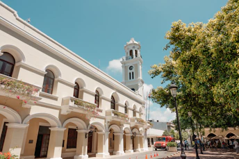 a white building with a clock tower in the background