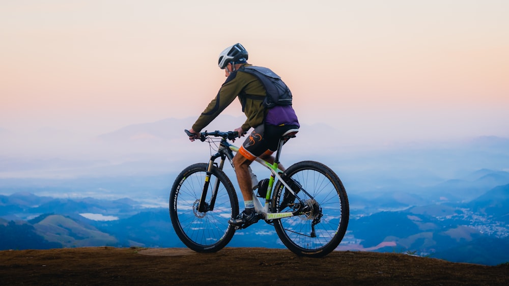 a man riding a bike on top of a mountain
