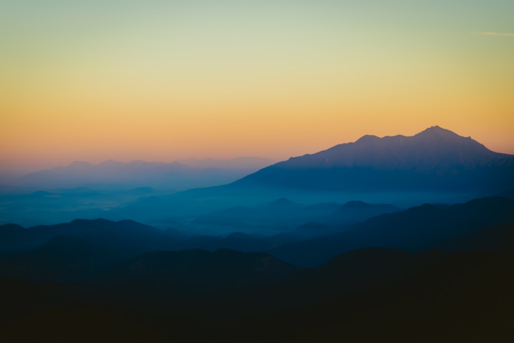 a view of a mountain range at sunset