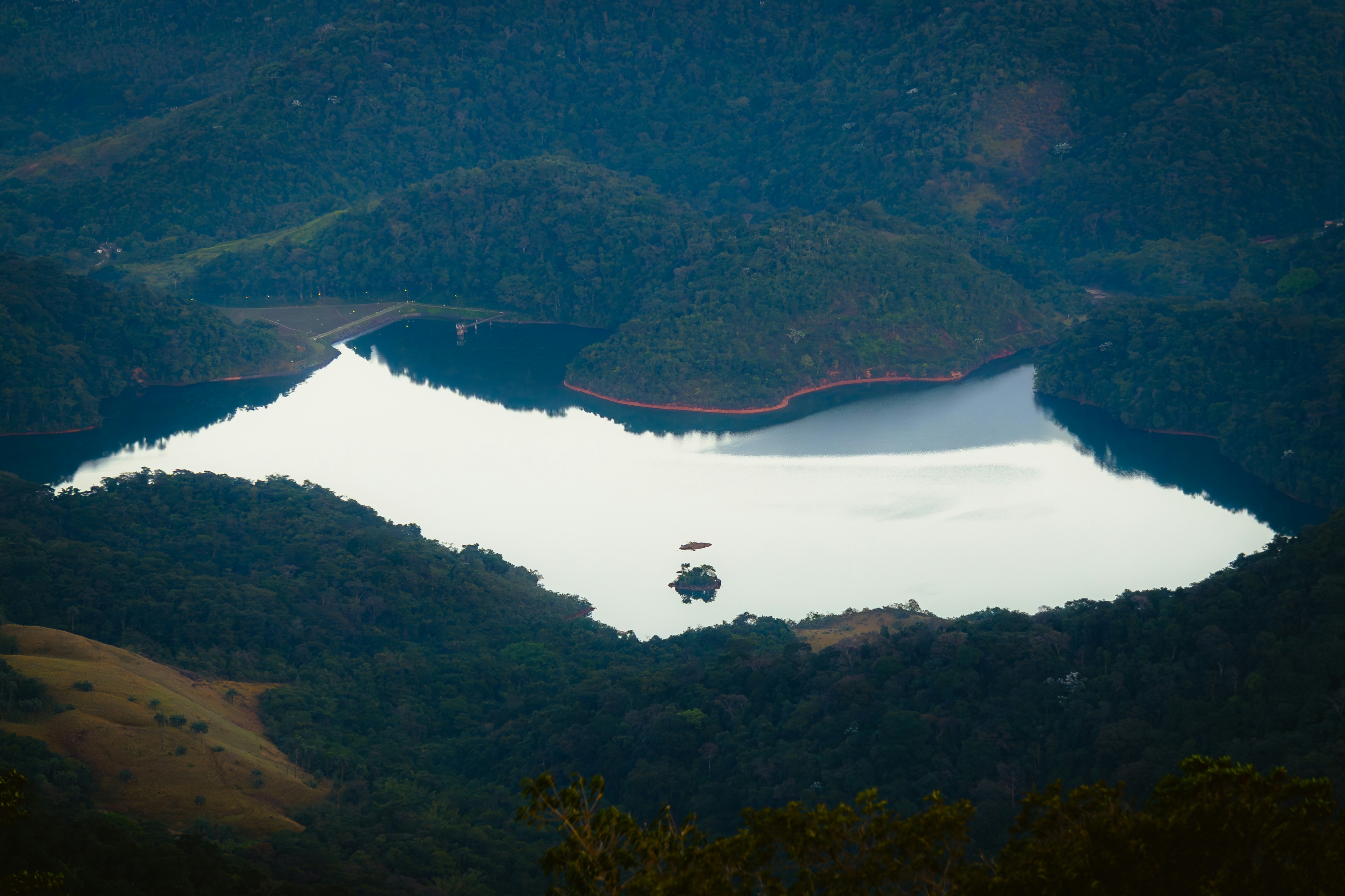 a large lake surrounded by lush green mountains