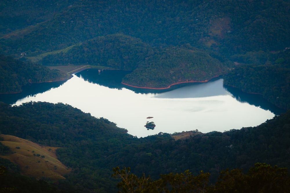 a large lake surrounded by lush green mountains