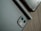 A close-up of a sleek smartphone with accessories on a wooden table.
