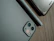 Close-up of a stylish smartphone resting on a wooden desk with accessories.