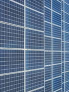 Neatly stacked solar panels stored securely inside the warehouse