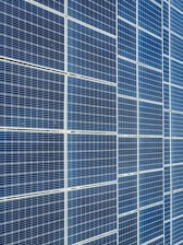 Neatly stacked solar panels stored securely inside the warehouse