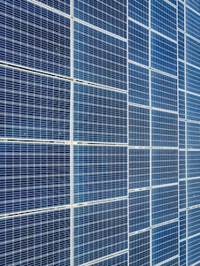 Photo of solar panels stacked and ready for shipment at a bustling Hong Kong warehouse.