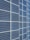 A large array of solar panels with a grid pattern, featuring dark blue and reflective surfaces aligned in a structured manner. The panels are arranged side by side, creating a uniform and organized layout.