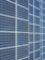 A large array of solar panels with a grid pattern, featuring dark blue and reflective surfaces aligned in a structured manner. The panels are arranged side by side, creating a uniform and organized layout.