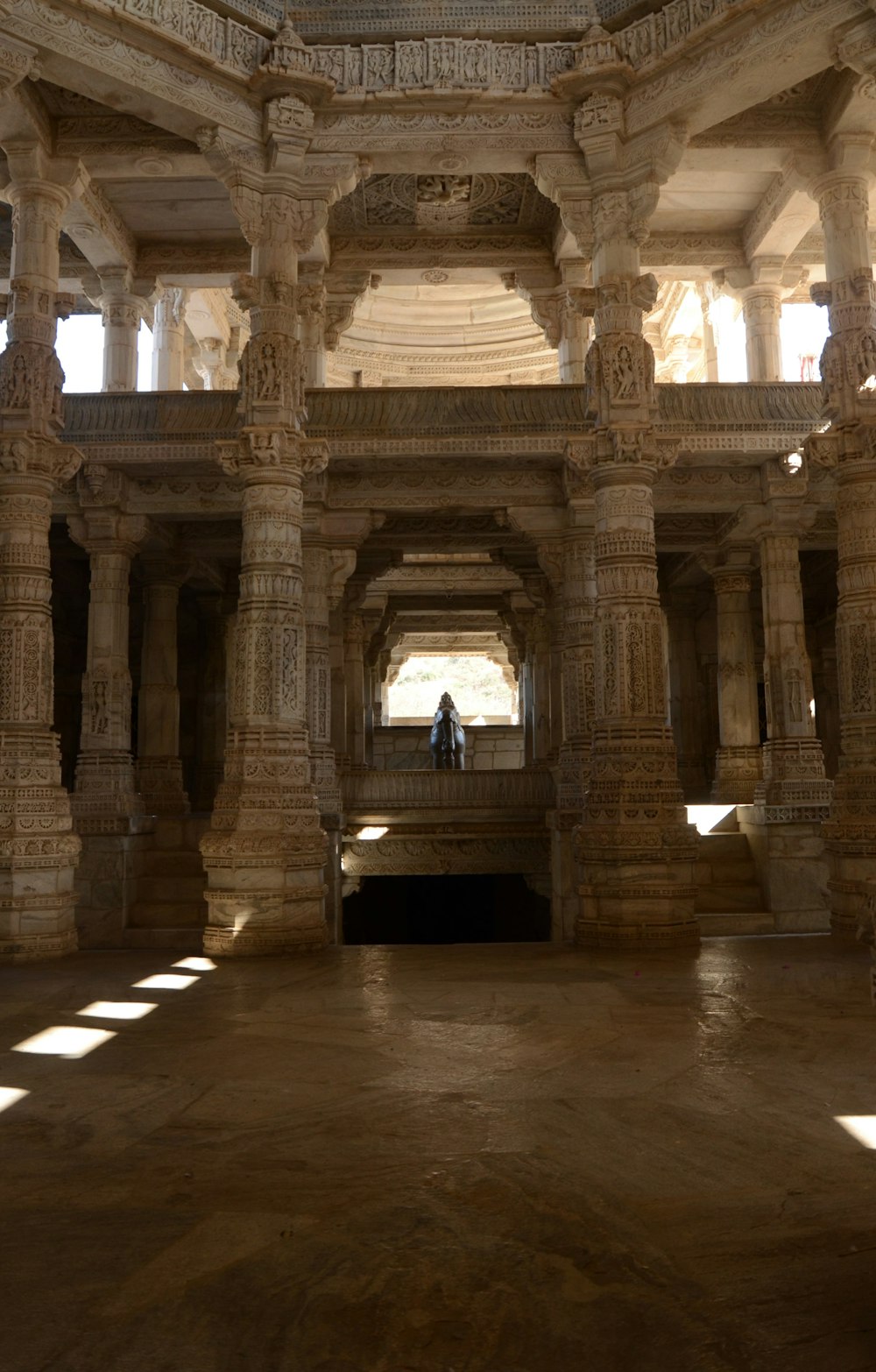 a person standing in a large room with columns